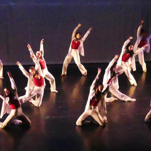 Students dancing with red and white garments.