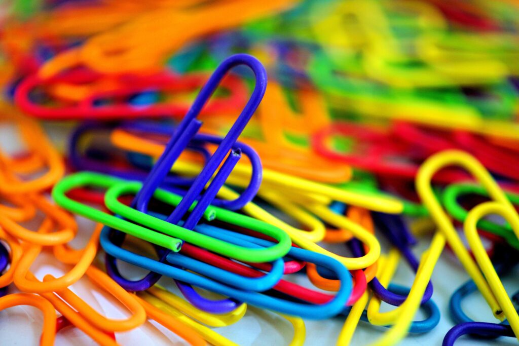 Colorful plastic paperclips in a close-up with a vibrant, multicolored arrangement.