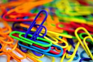 Colorful plastic paperclips in a close-up with a vibrant, multicolored arrangement.